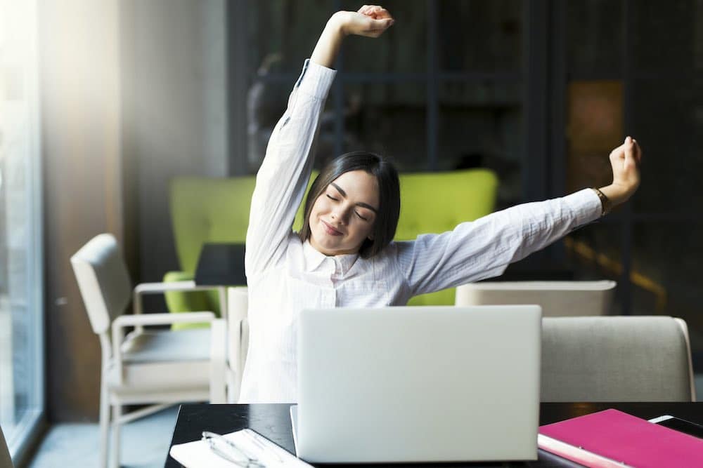 Woman stretching at her desk