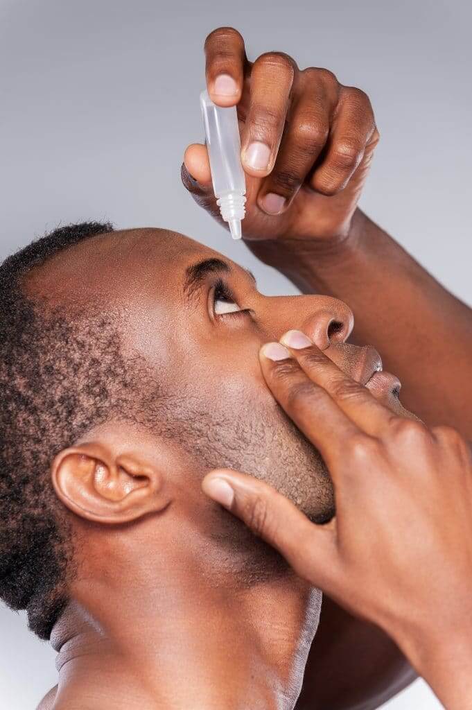 Man putting in LASIK recovery eye drops