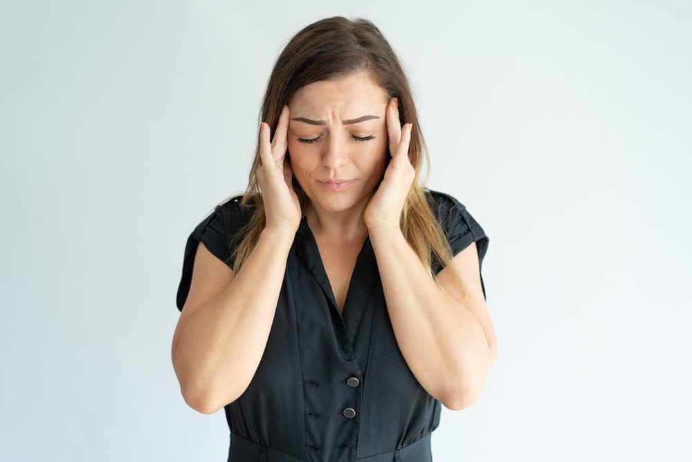 Woman-Experiencing-Headache Woman Experiencing Headache 2
