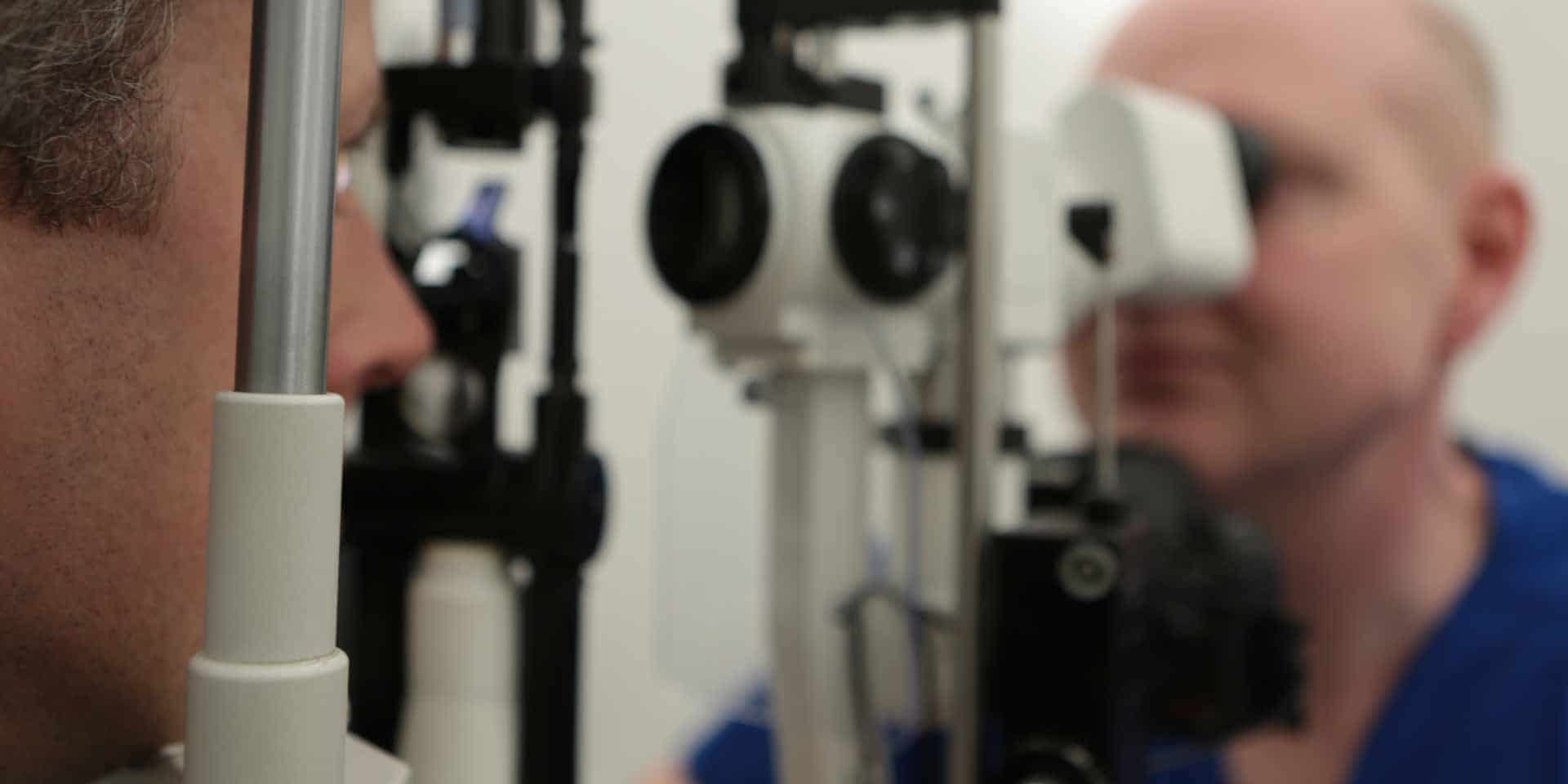 David Allamby examining a patient's eye