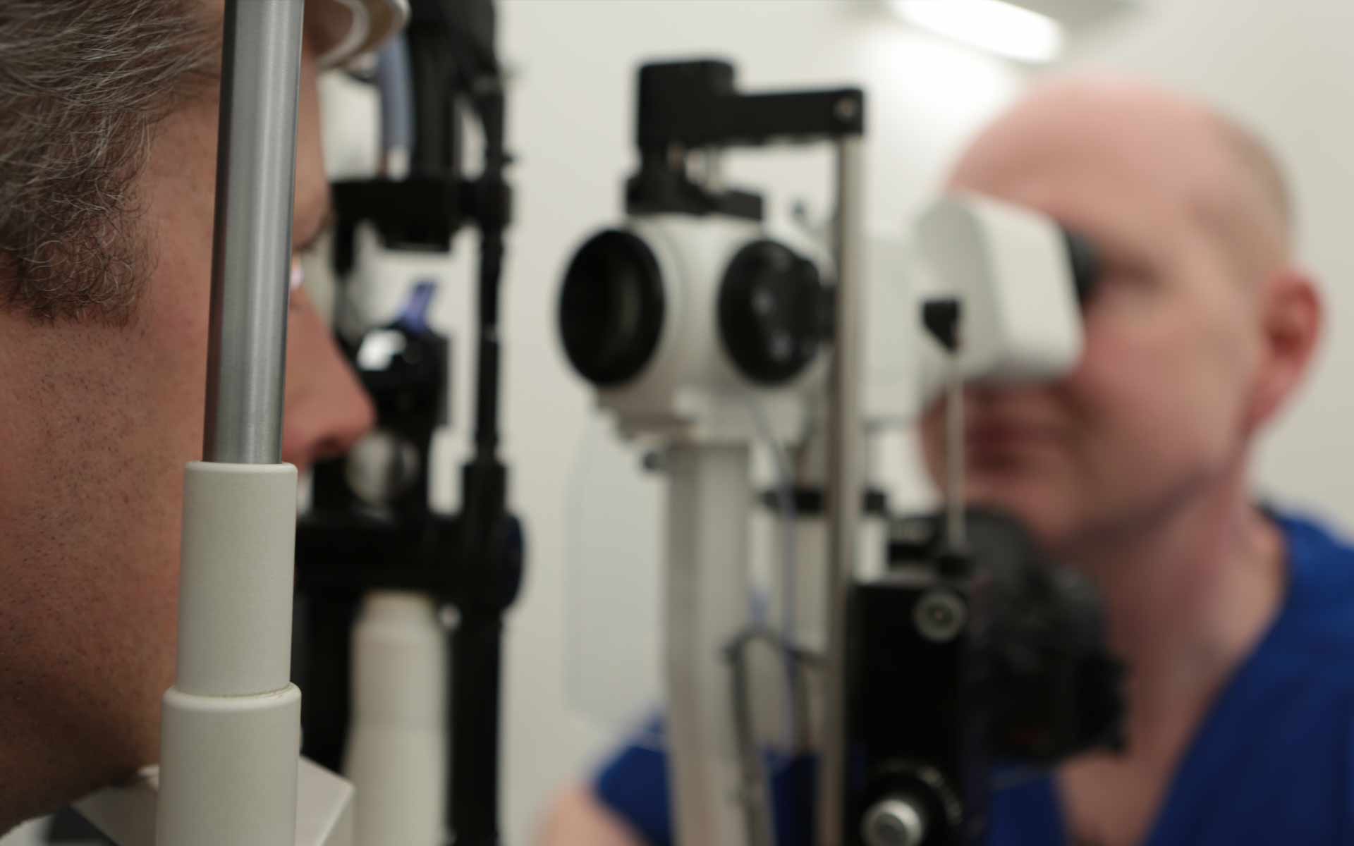 David Allamby examining a patient's eyes