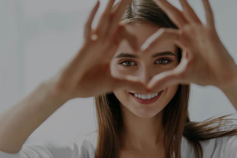 Woman showing love heart with hands