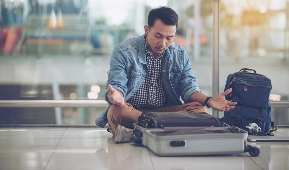 Man looking for lost glasses in his suitcase