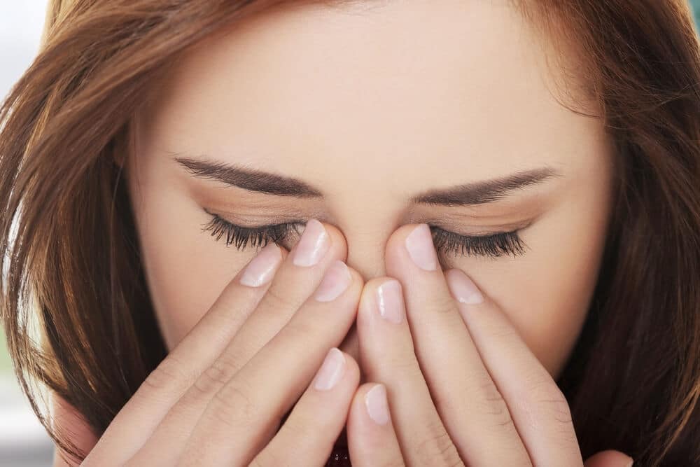 Woman rubbing her eyes