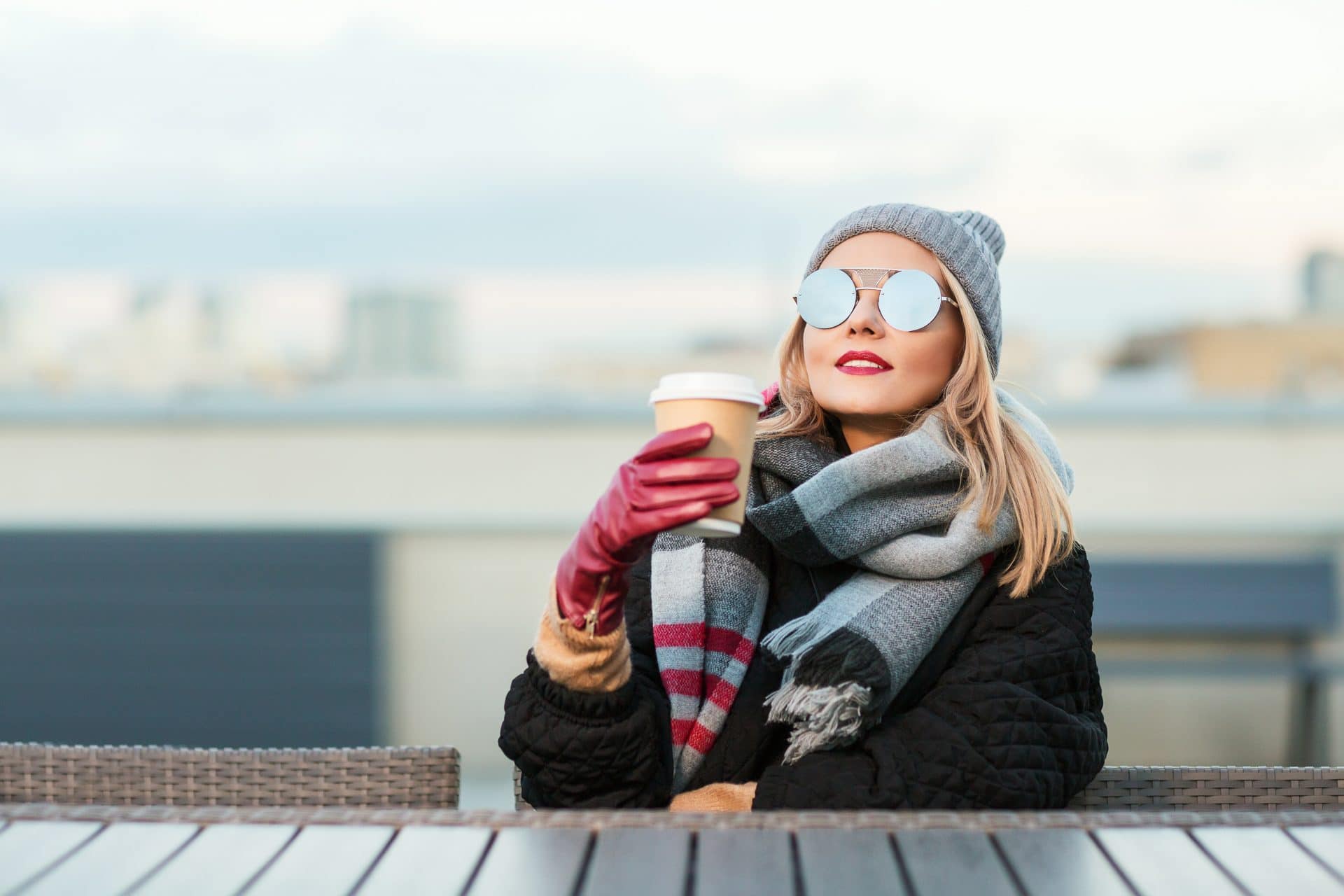 Woman drinking coffee wearing sunglasses