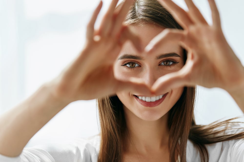 Woman showing love heart with hands Woman showing love heart with hands