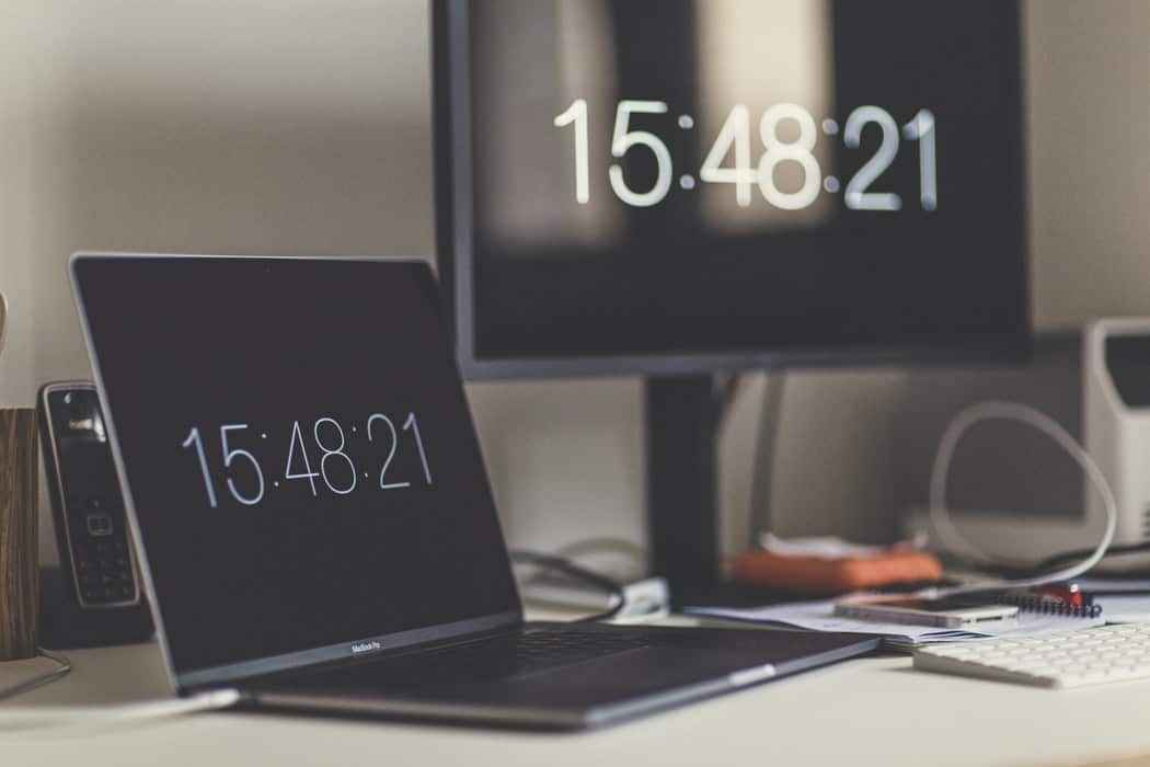 Photo of a desk with a laptop and monitor