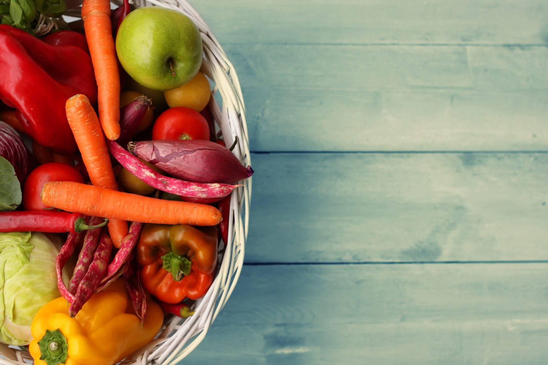 Basket of vegetables on a wooden table