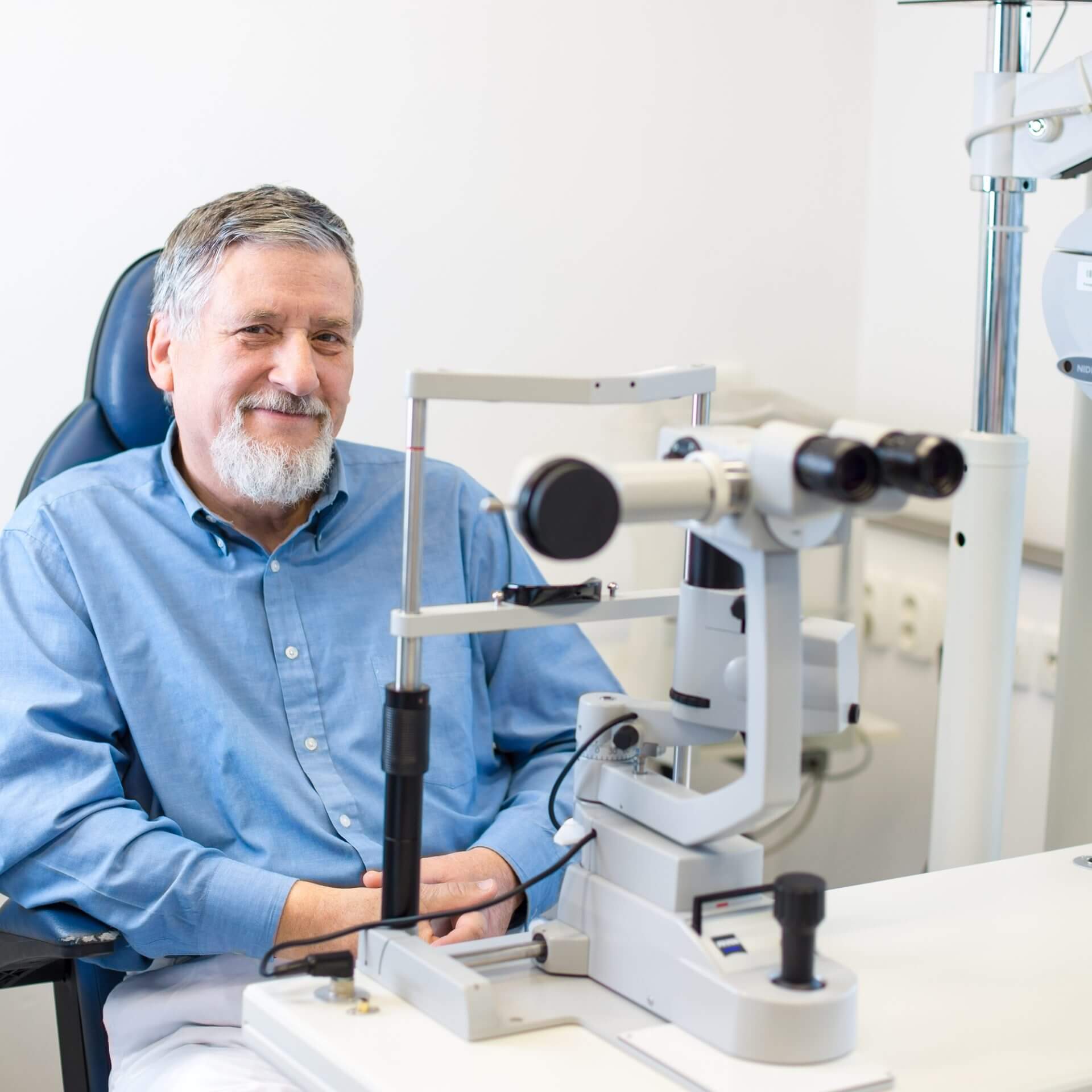 Man smiling while waiting to have his eyes tested