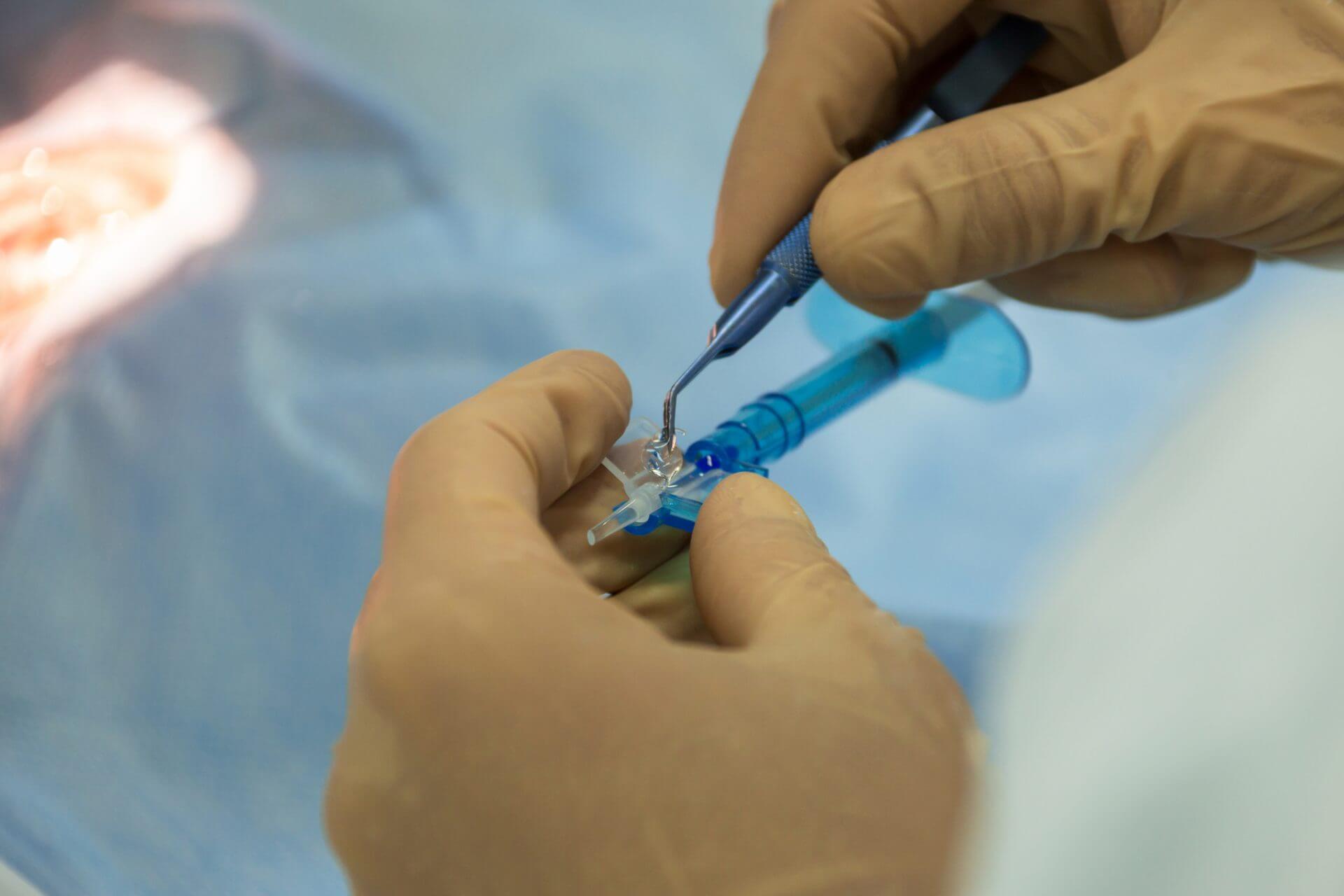 Surgeon picking up an implantable lens