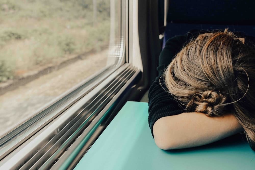 Woman resting her head on a train table