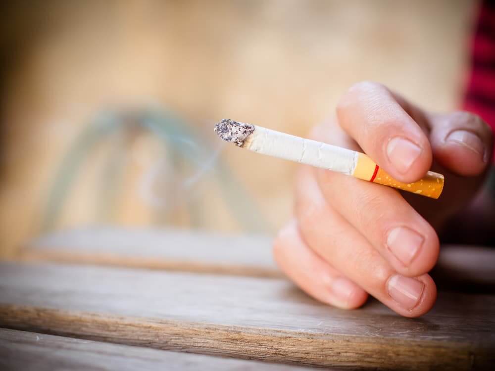 Hand holding a cigarette