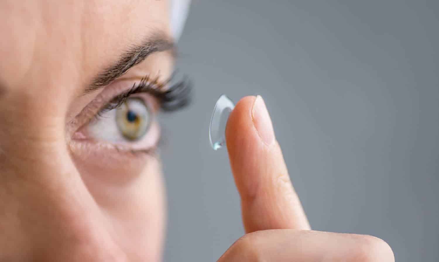 Woman putting a contact lens into her eye